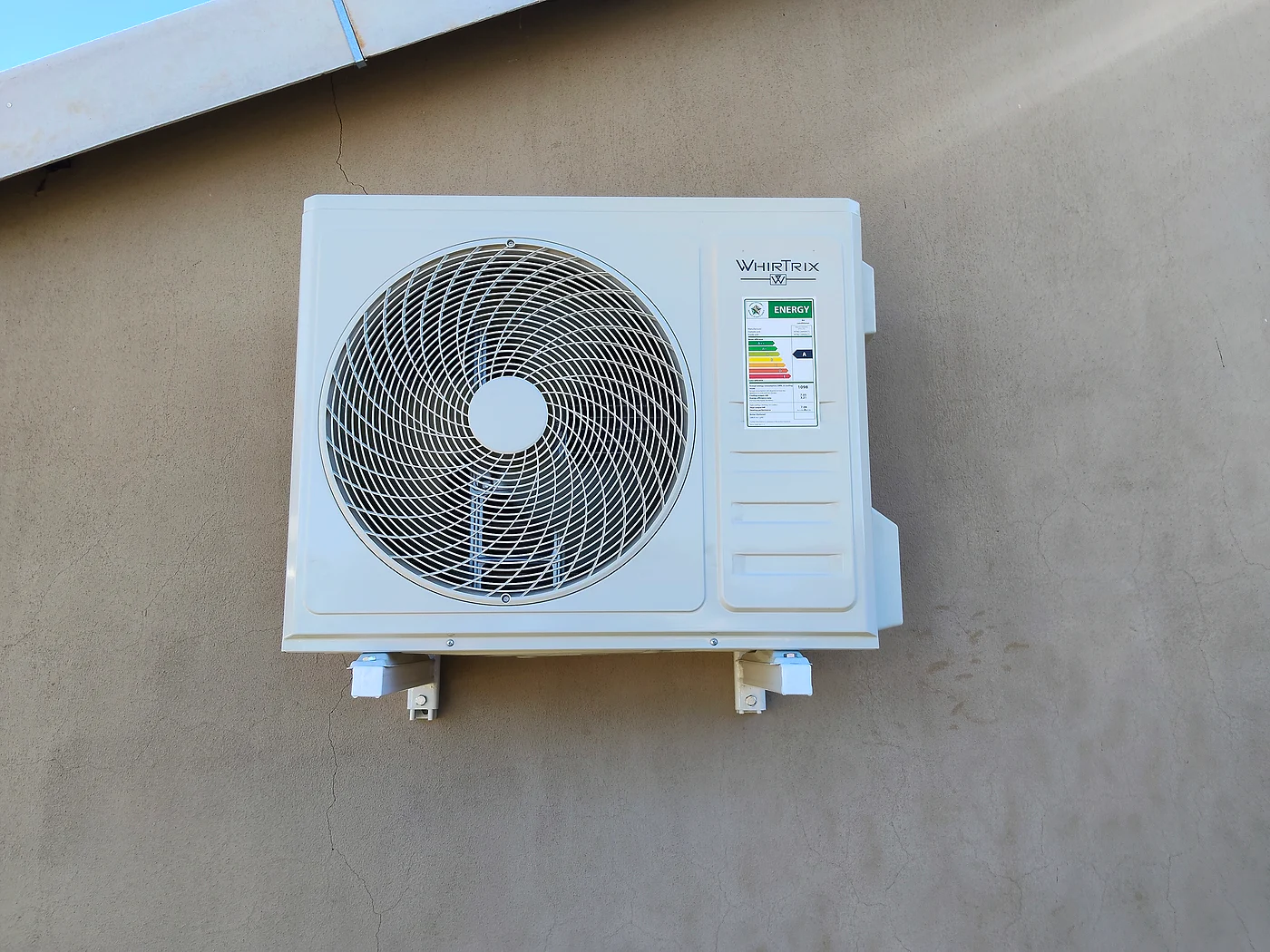 Outdoor air-conditioning condenser installed on an exterior wall